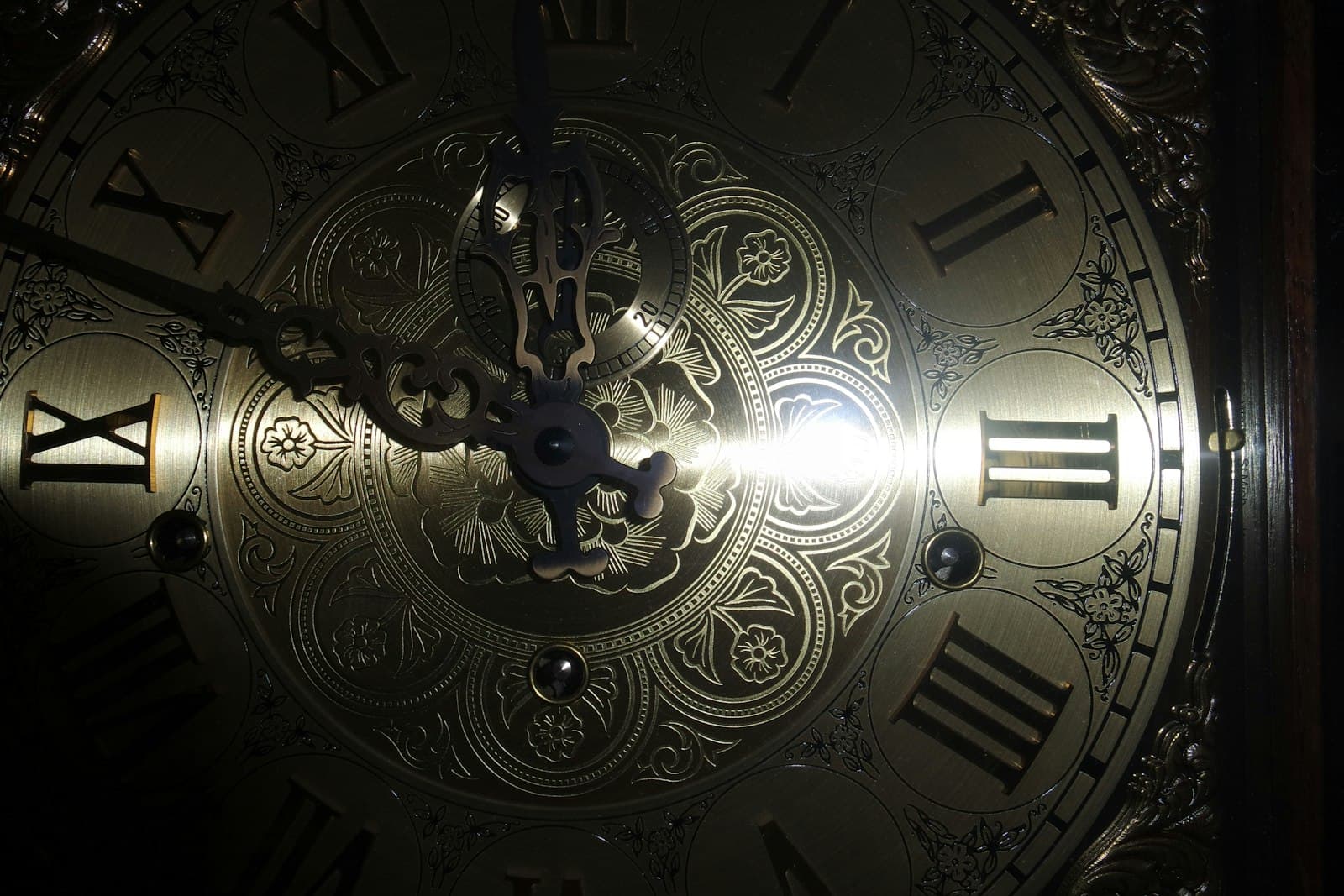 An antique brass clock face with Roman numerals