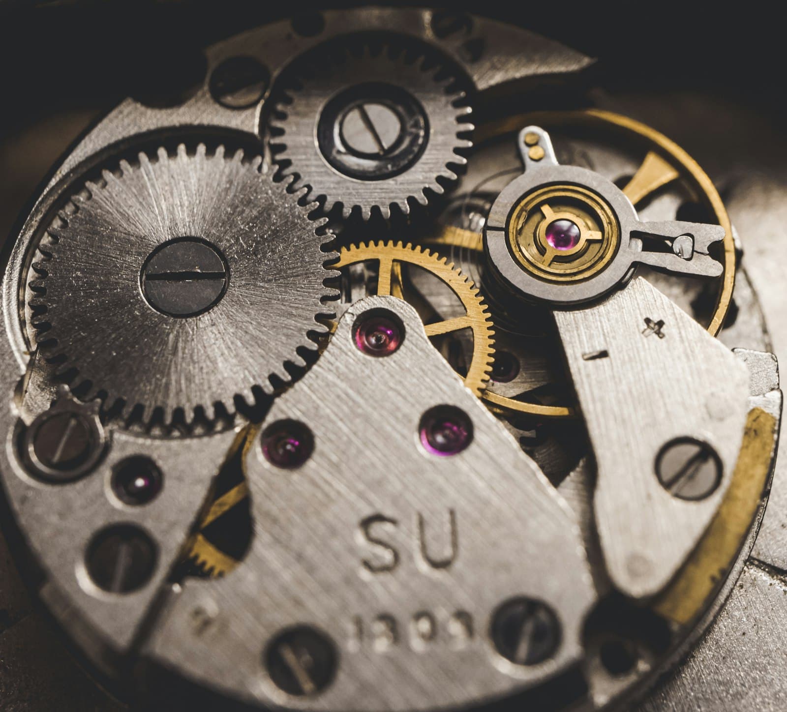 A watch caliber mid-assembly, the balance wheel not yet fitted