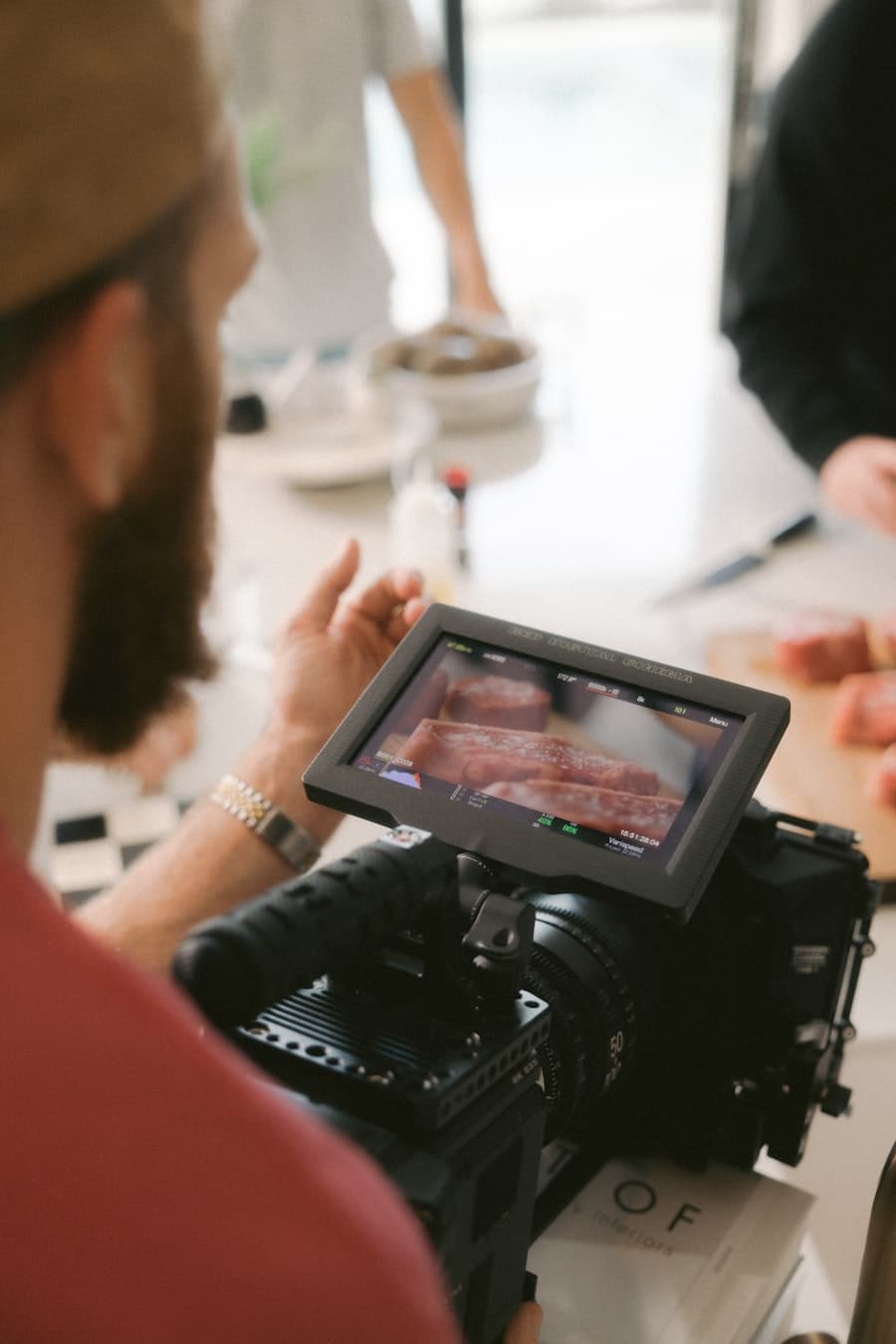 Reid Callahan checking a shot through a camera monitor on set