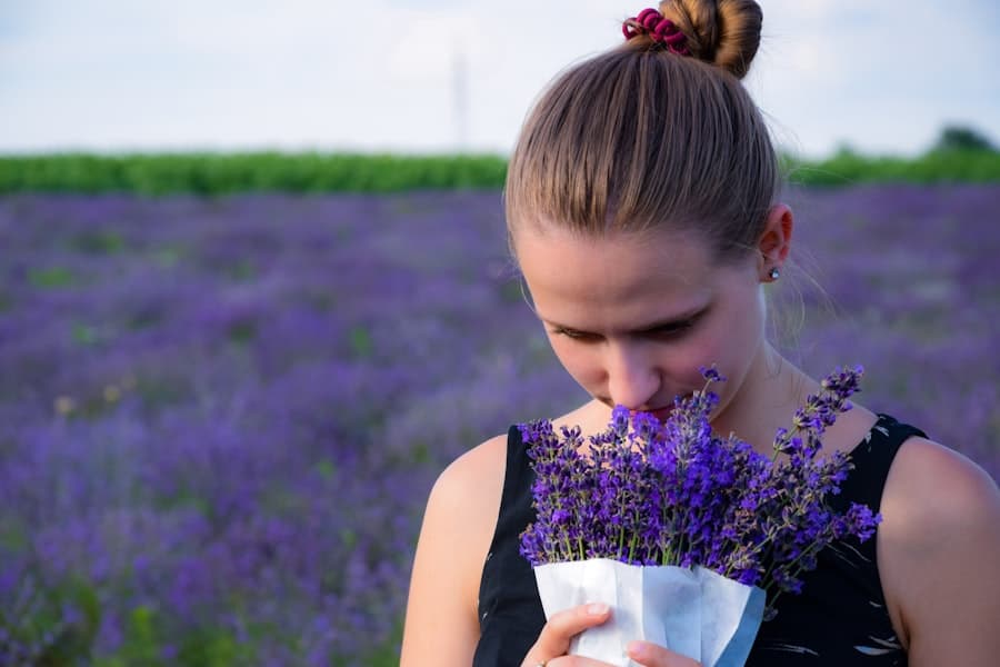 Camille Rousseau smelling a bundle of fresh lavender